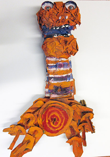 Brent Brown | BRB437 | Long Strange, 2017 | 
	 Cardboard, Mixed Media | 24 x 34 x 9 in. (61 x 86.4 x 22.9 cm) at the Outsider Folk Art Gallery